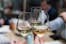 three people having a toast using three clear crystal wine glasses