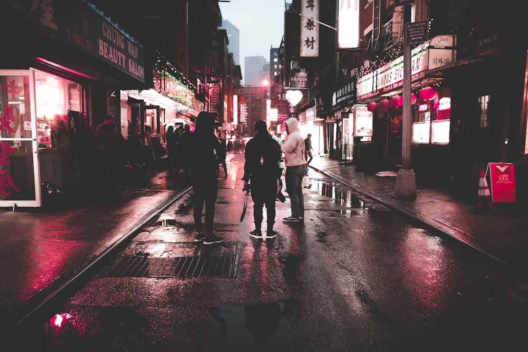 people standing on street at night