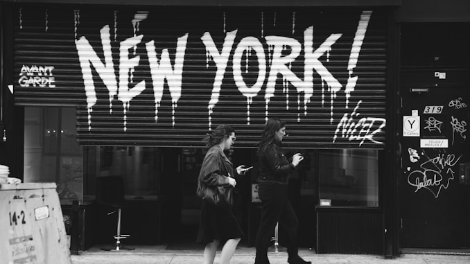 grayscale photography of two women walking