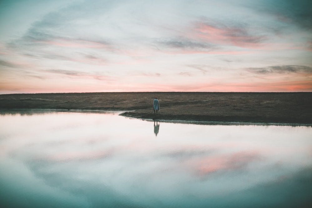 person near lake water