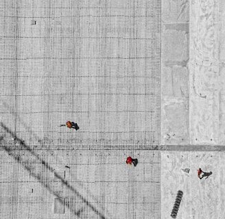 aerial photo of three person walking on floor at daytime
