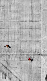 aerial photo of three person walking on floor at daytime