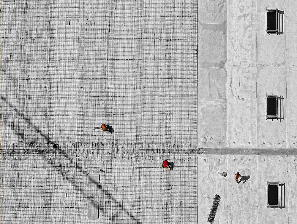 aerial photo of three person walking on floor at daytime