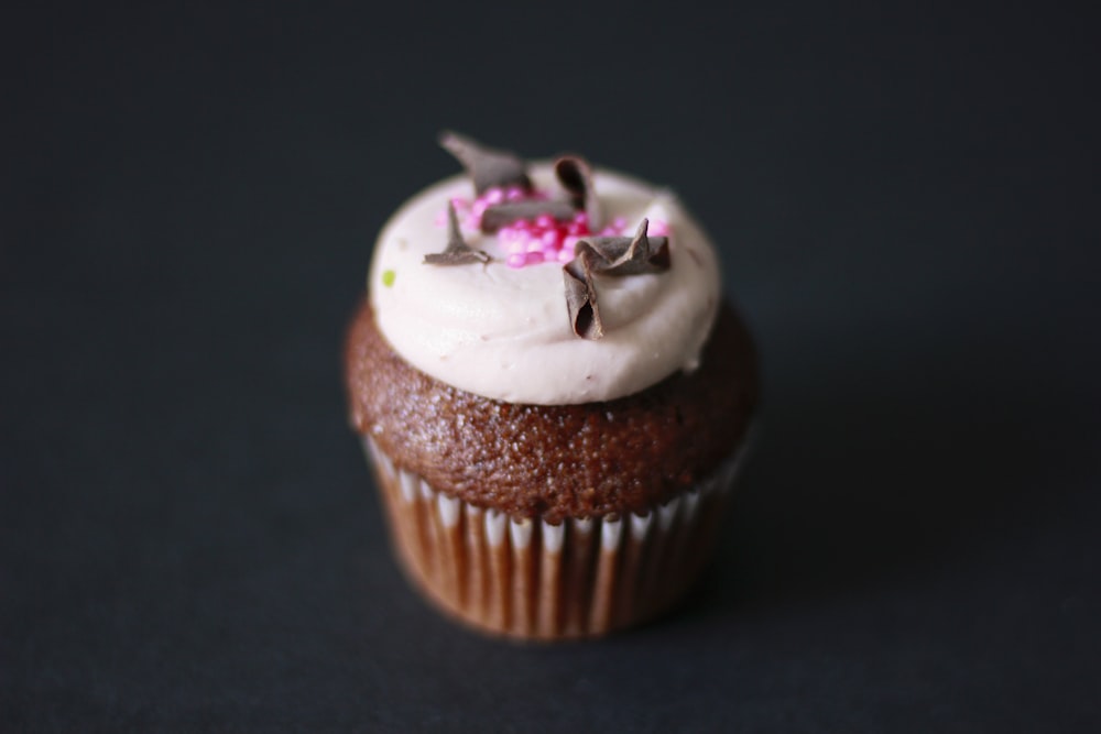 chocolate cupcake with white icing and grated chocolate