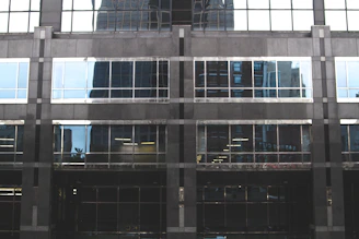Close-up of a sleek office building facade with mirrored windows.