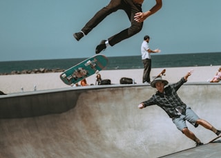 two men skateboarding on bowl ramp