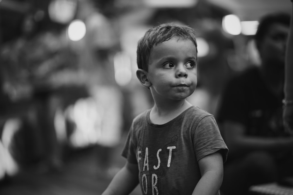 grayscale photo of boy in crew-neck shirt