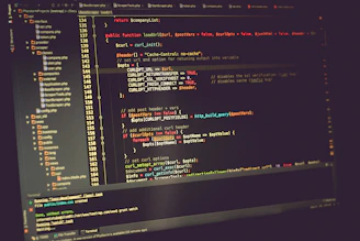 A focused developer working on code with multiple screens showing PHP and JavaScript scripts.