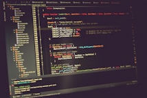 A computer screen displaying lines of code in a development environment. The code includes PHP syntax with functions, variables, and comments. The background is dark, and there are several open tabs with file names on the side.