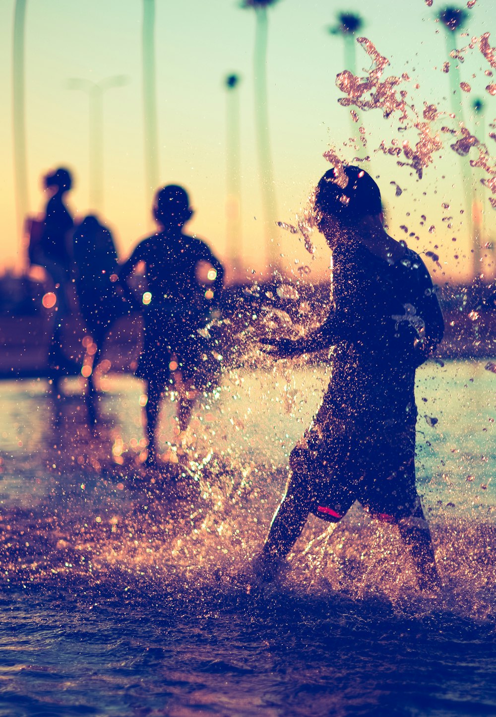 a group of people standing in a body of water