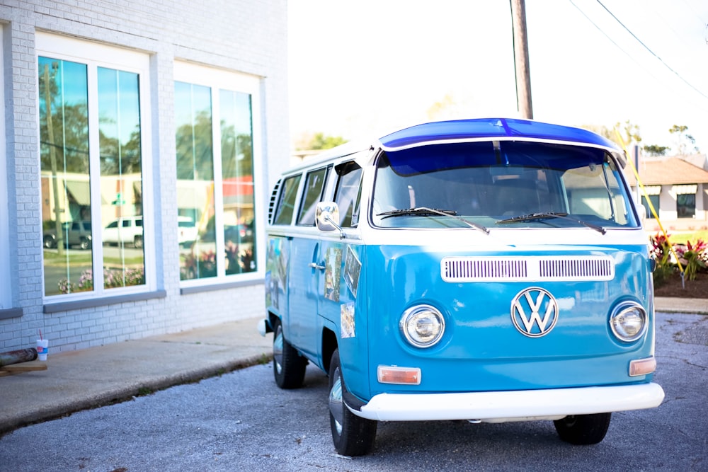 teal Volkswagen Samba in front of building