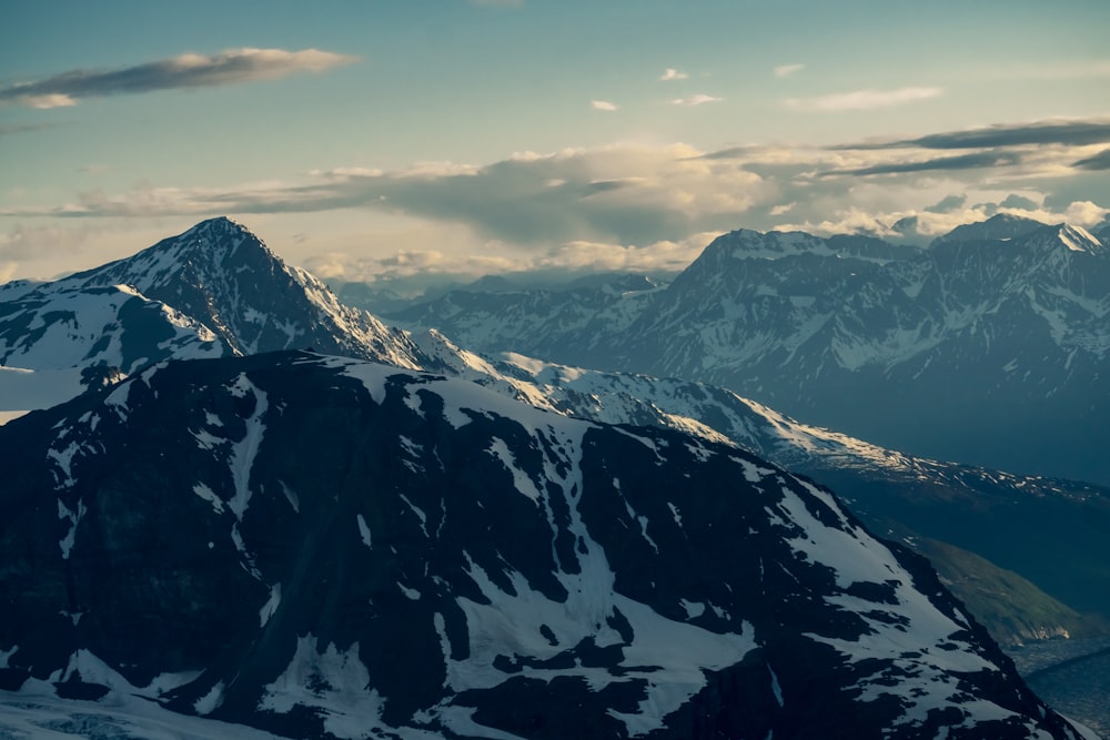 snowy mountain covered by clouds