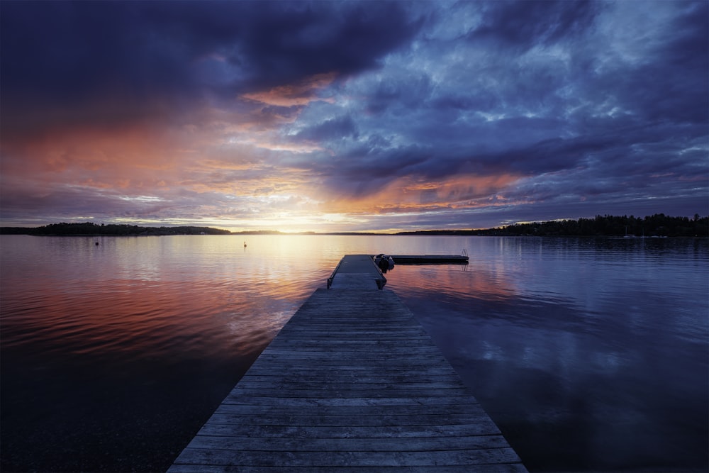 golden hour photography of docking pier on body of water