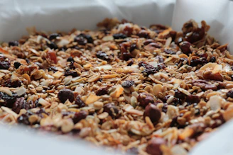 Close-up of granola clusters highlighting the texture and wholesome ingredients like oats, seeds, and nuts.