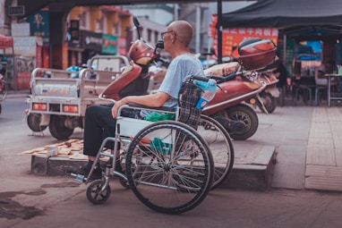 man sitting on wheelchair