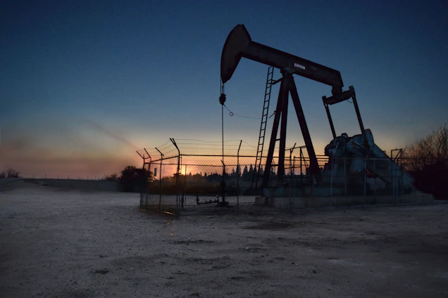 Oil field automation equipment operating under a sunset sky in Venezuela's Orinoco Belt.