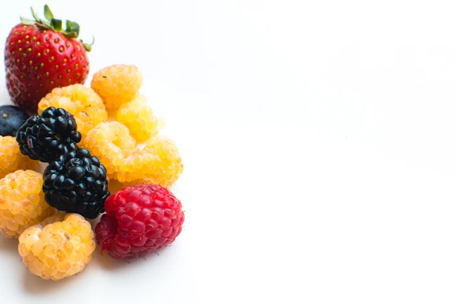 A bright, stylized image of assorted berries arranged in a cheerful pattern.