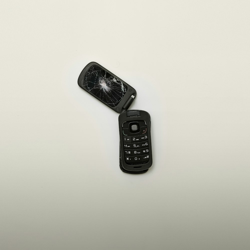broken black flip phone \