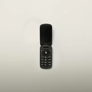turned-off black flip-phone