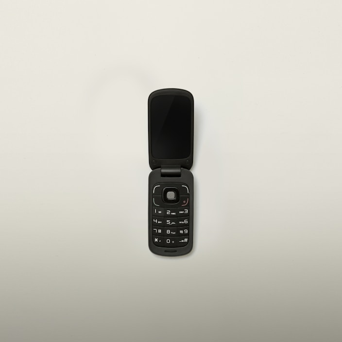 A variety of stylish flip phones displayed on a table.