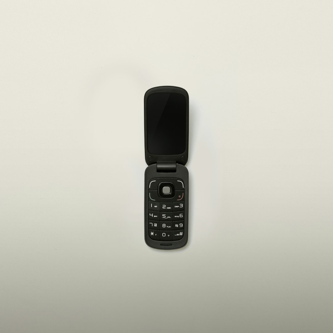 turned-off black flip-phone