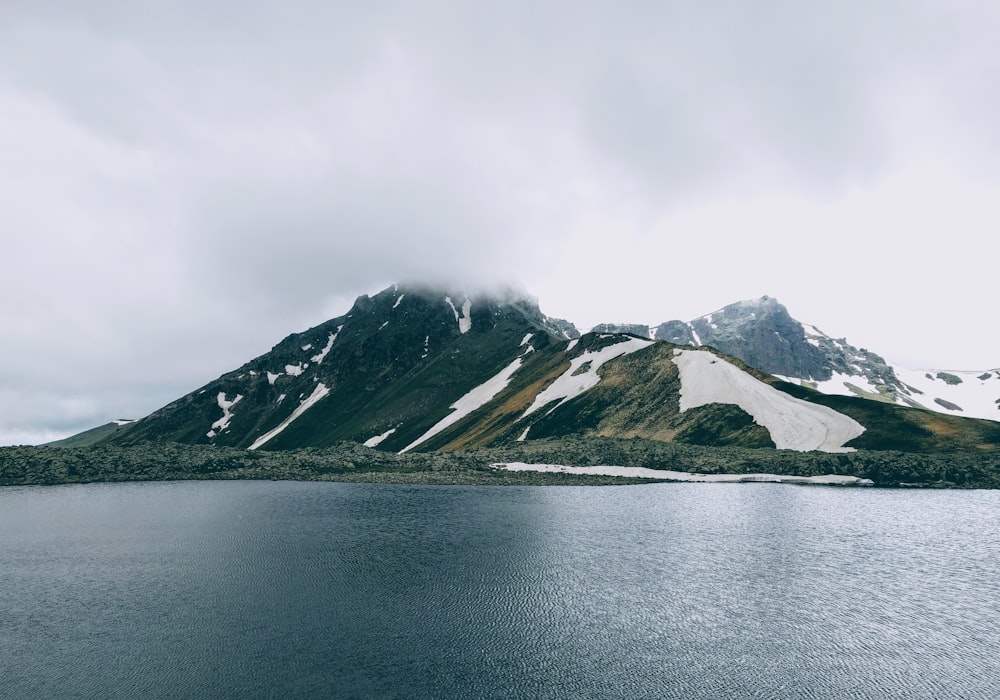 mountain beside body of water