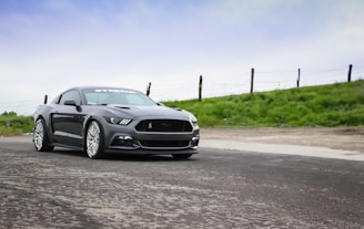 gray coupe park near grass field