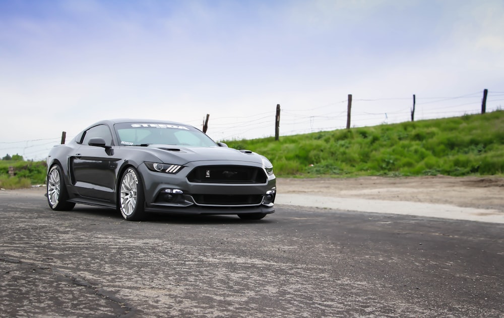 gray coupe park near grass field