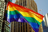 High-resolution photo capturing vibrant pride parade colors in an urban setting.