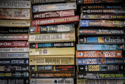A cozy stack of recently shipped paperback books with a cardboard box and a sealed address label.