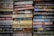 Stacks of paperback books arranged closely together, with a variety of titles and authors visible on the spines. The colors of the book covers range from muted tones to bright hues, creating a mosaic of literary works.