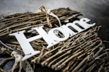 Metal letter wall hanging spelling 'home' in sleek, brushed metal finish on a neutral backdrop.
