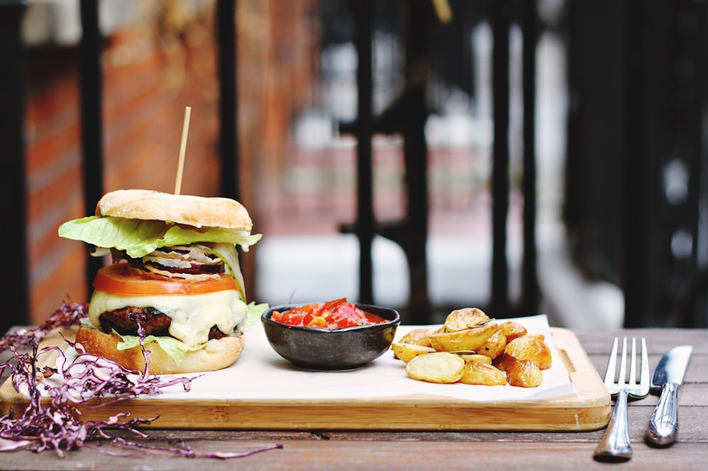 ham burger beside bowl on tray