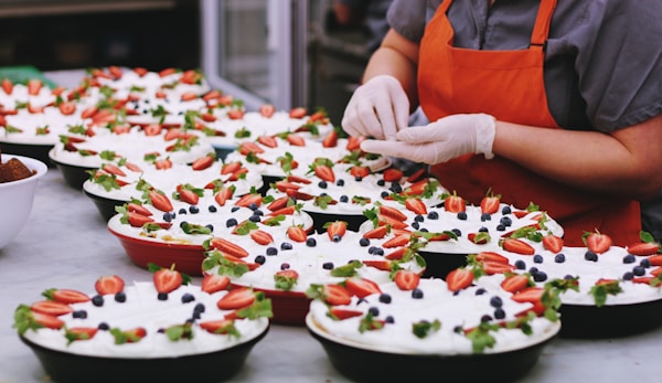 Person decorating dishes on table