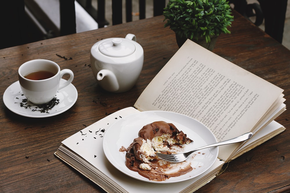 a plate of food and a cup of tea on a table