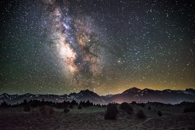silhouette of mountains under milky way galaxy