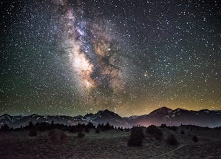 silhouette of mountains under milky way galaxy