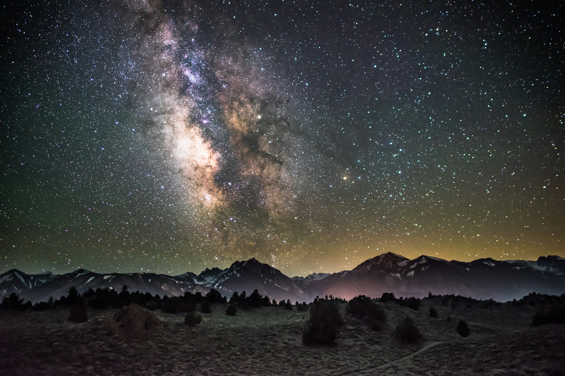 silhouette of mountains under milky way galaxy