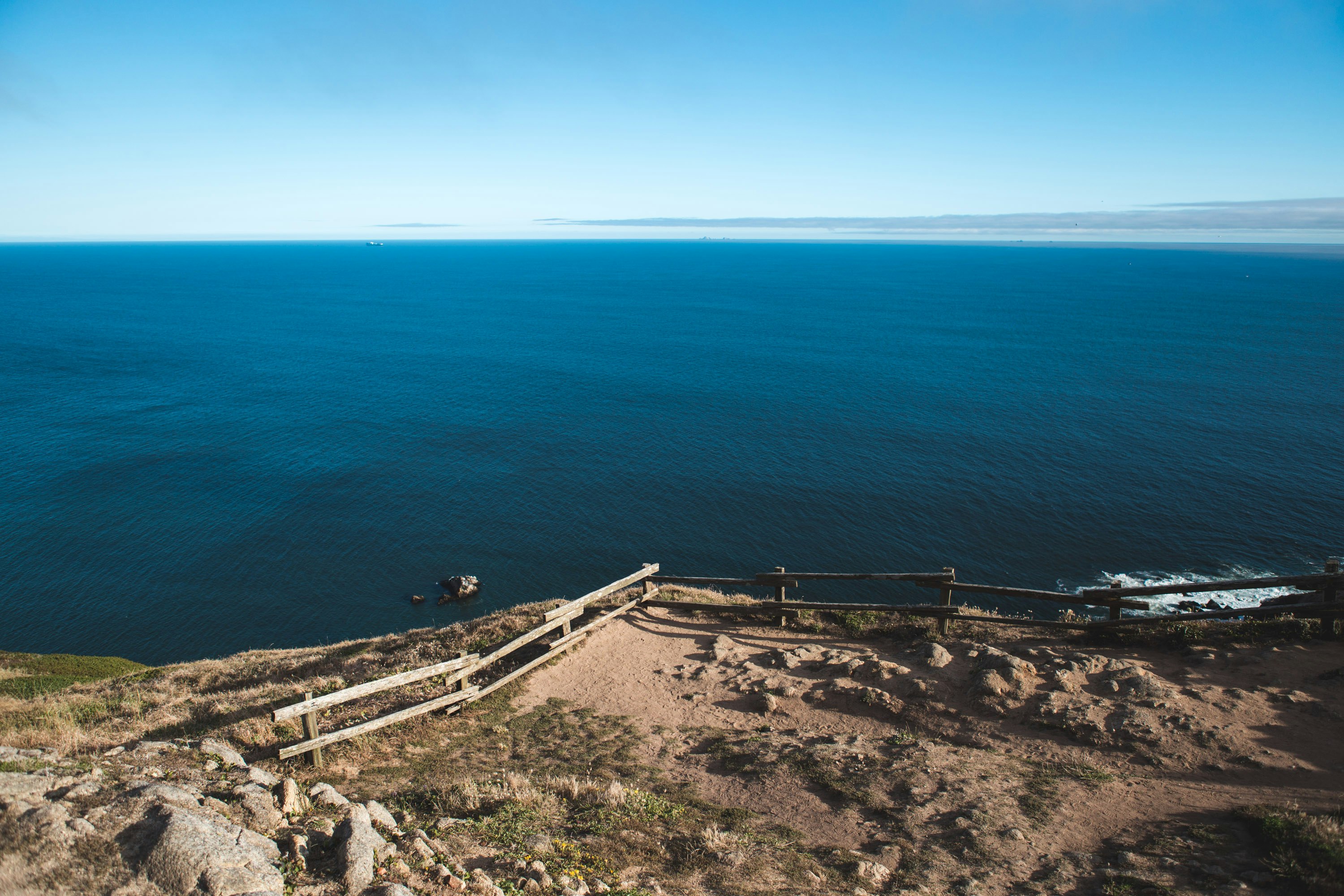 brown wooden dock on blue sea during daytime