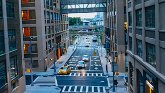 road between brown and black high-rise buildings