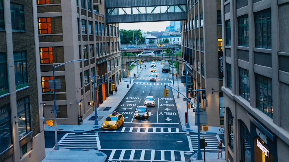 road between brown and black high-rise buildings