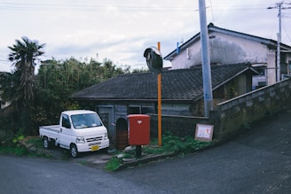 Photo of a RuralClear Trash truck arriving at a quiet country home surrounded by trees.