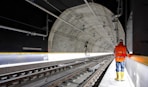 man standing beside train rail