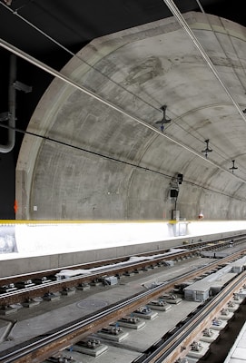 man standing beside train rail