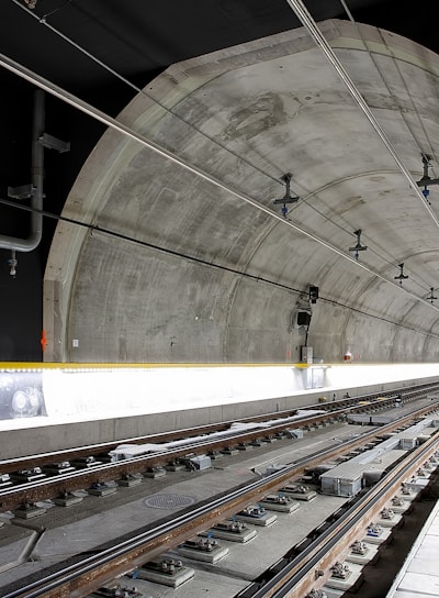 man standing beside train rail