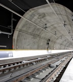 man standing beside train rail