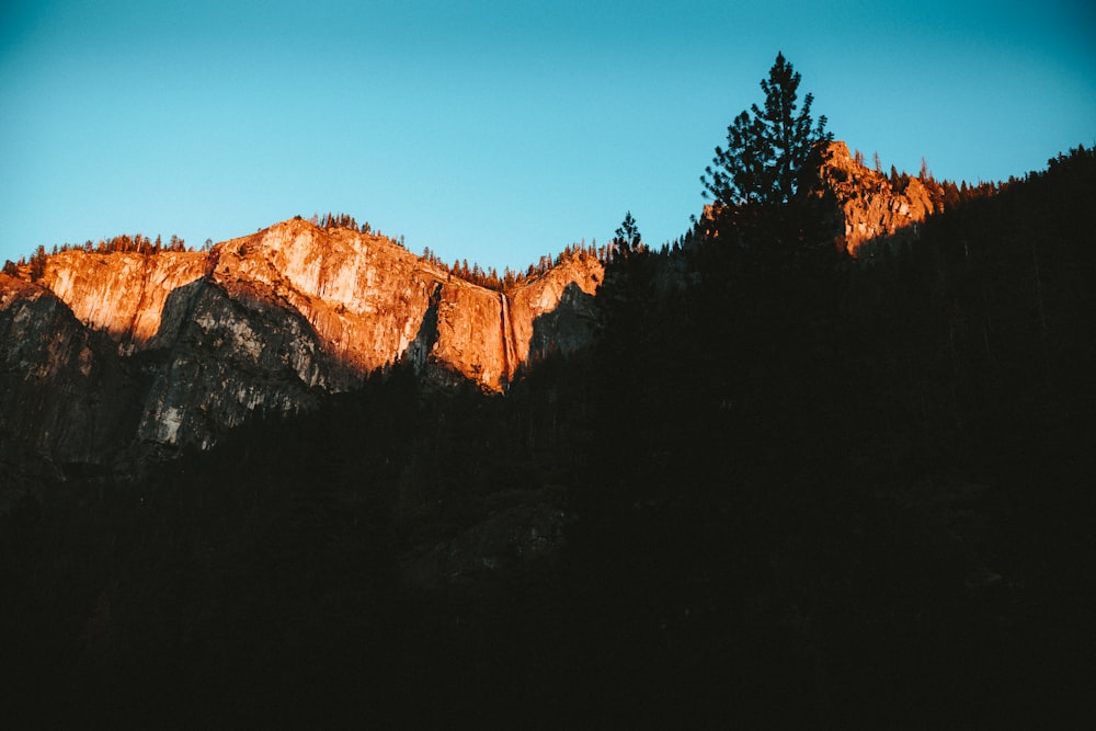 brown rocky mountain under blue sky during daytime