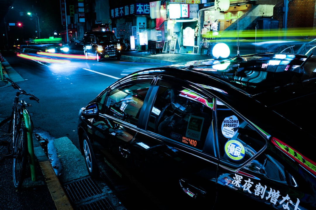 black car beside black and green bicycle