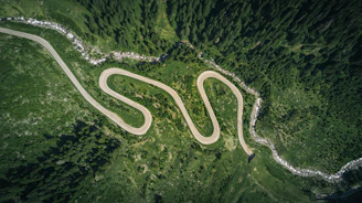 aerial view of asphalt road surrounded by trees
