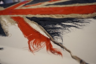 Close-up of a retro national team football shirt with faded colors and old-style badge.